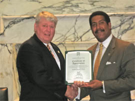 Former (MML) Maryland Municipal League President and Councilman Stewart Cumbo presenting Maryland House Speaker, Michael Busch,&nbsp;with a MML Certificate of Appreciation 